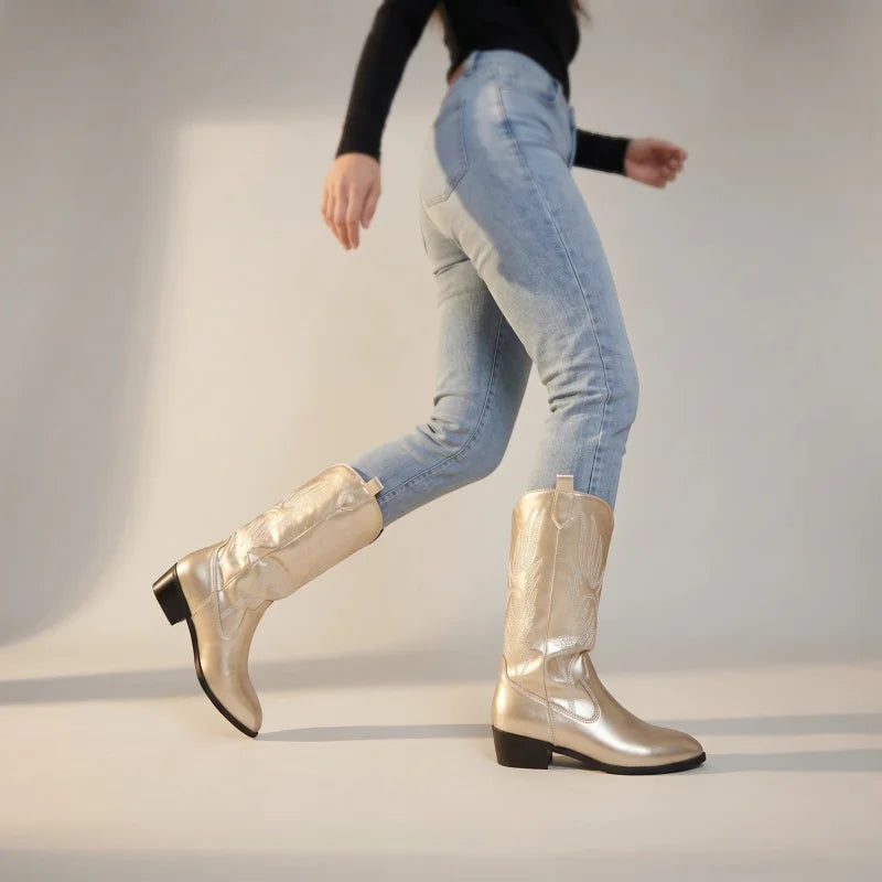 Yehaw gold vegan leather mid-calf cowgirl boots with a pointed toe and medium heel worn with light blue jeans.