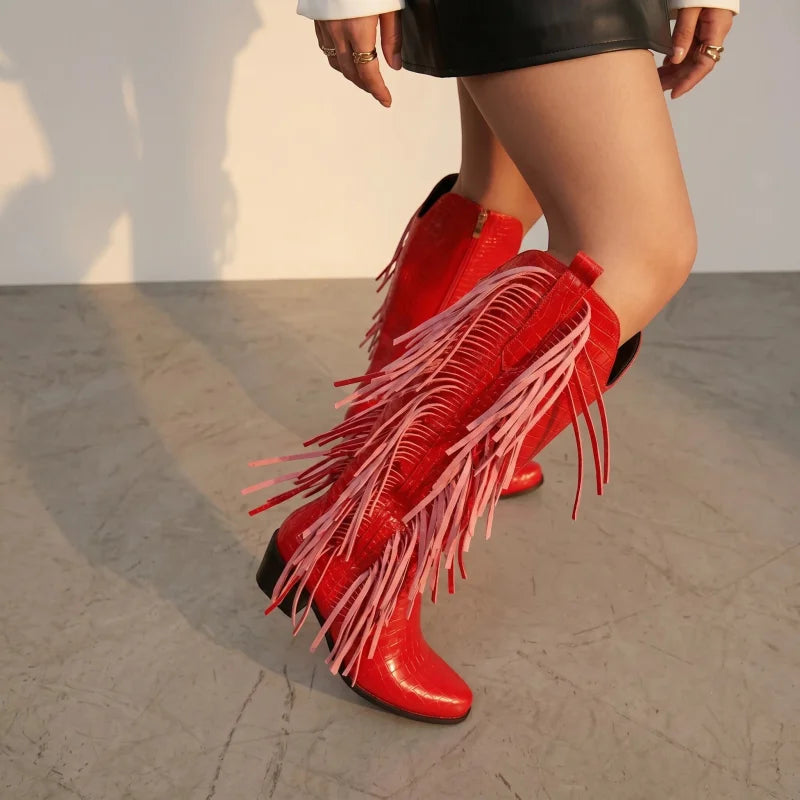 Yehaw red knee-high vegan leather cowgirl boots with fringe detail and square toe worn by a model