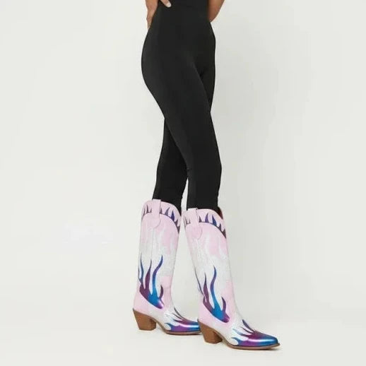 Model wearing Yehaw pink vegan leather mid-calf cowgirl boots with flame patterns and a round toe