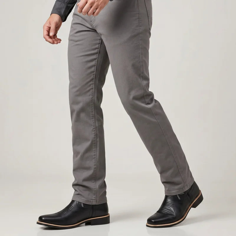 Yehaw black vegan leather cowboy boots with round toe and low heel worn by a man in grey trousers