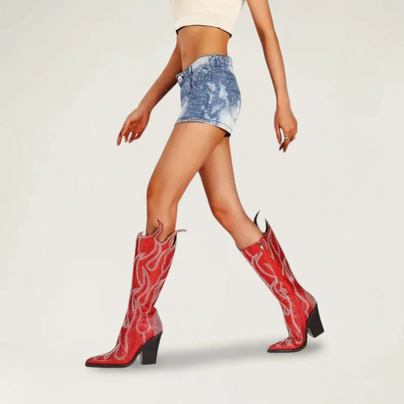 Yehaw red vegan microfibre knee-high cowgirl boots with square toe and flame embroidery worn by a model in denim shorts