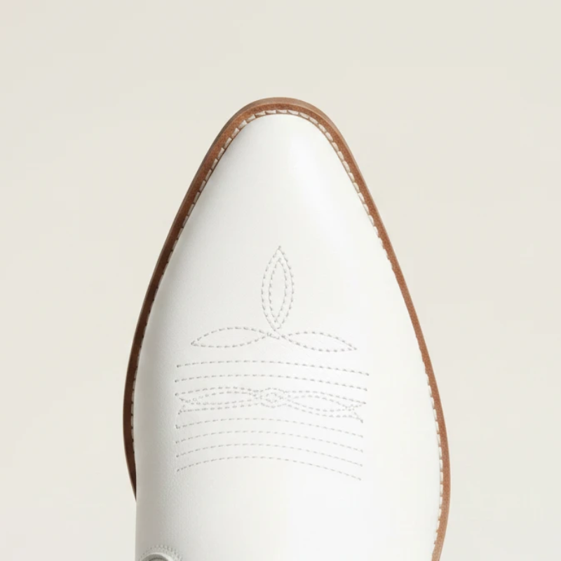 Yehaw Alejandra white vegan leather mid-calf cowgirl boots with fringe detail and pointed toe worn with blue jeans