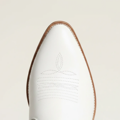Yehaw Alejandra white vegan leather mid-calf cowgirl boots with fringe detail and pointed toe worn with blue jeans