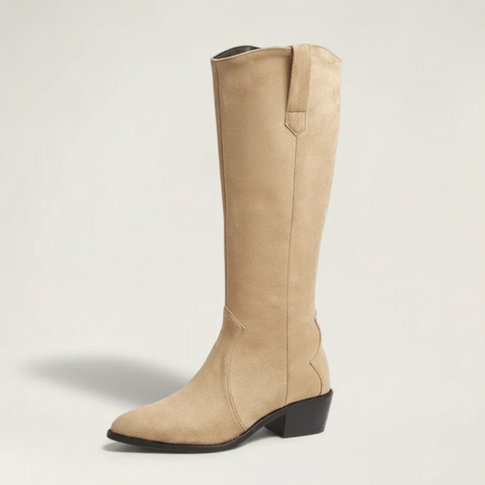 Yehaw beige vegan suede knee-high cowgirl boots with a pointed toe and side zip worn by a woman in denim shorts