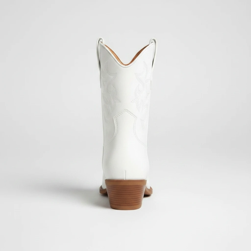 Yehaw CARLA white vegan leather ankle cowgirl boots with pointed toe and medium heel worn by a woman in denim shorts