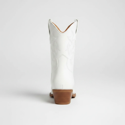 Yehaw CARLA white vegan leather ankle cowgirl boots with pointed toe and medium heel worn by a woman in denim shorts