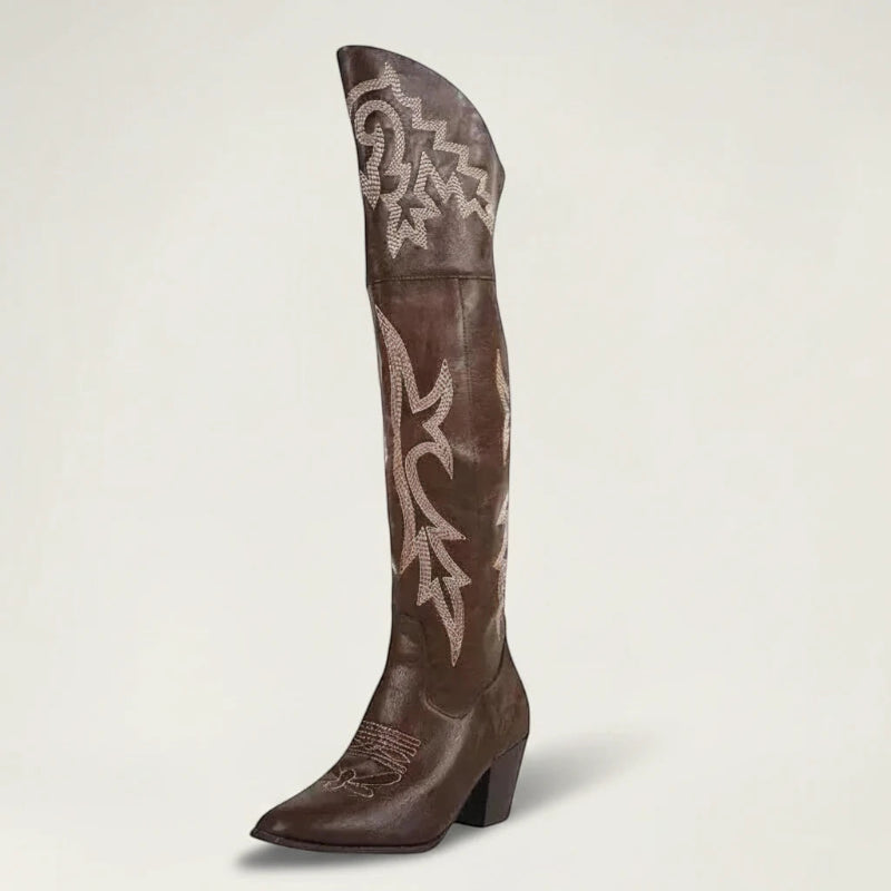 Yehaw brown vegan leather knee-high cowgirl boots with white western embroidery and a pointed toe.