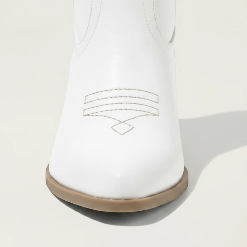 Yehaw white vegan leather ankle-height cowgirl boots with pointed toe and high heel.