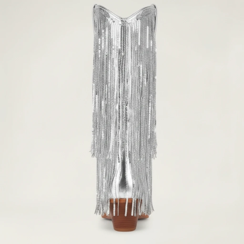 Yehaw silver knee-high vegan leather cowgirl boots with metallic fringe detailing and a pointed toe.