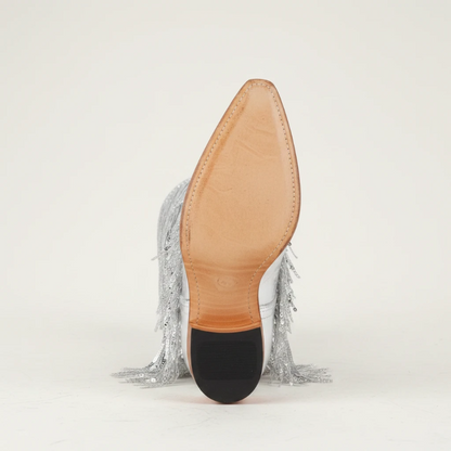 Yehaw silver knee-high vegan leather cowgirl boots with metallic fringe detailing and a pointed toe.