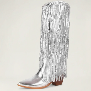 Yehaw silver knee-high vegan leather cowgirl boots with metallic fringe detailing and a pointed toe.