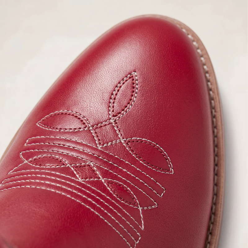 Yehaw red vegan leather mid-calf cowgirl boots with white star embroidery and a heart-shaped buckle strap.