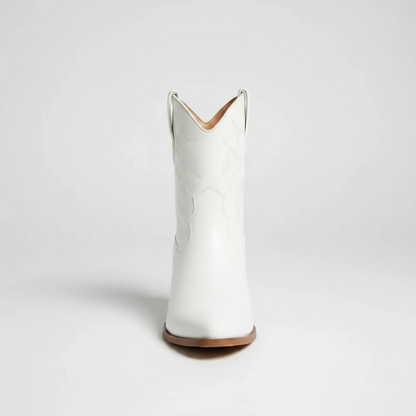 Yehaw CARLA white vegan leather ankle cowgirl boots with pointed toe and medium heel worn by a woman in denim shorts