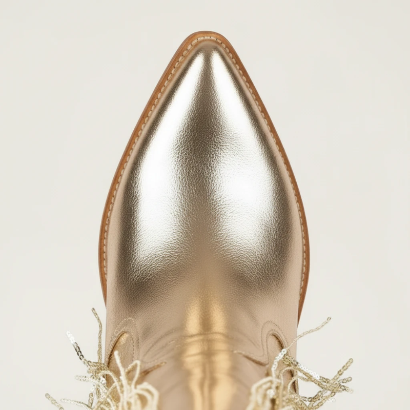 Yehaw gold vegan leather mid-calf cowgirl boots with long shimmering fringe and a pointed toe.