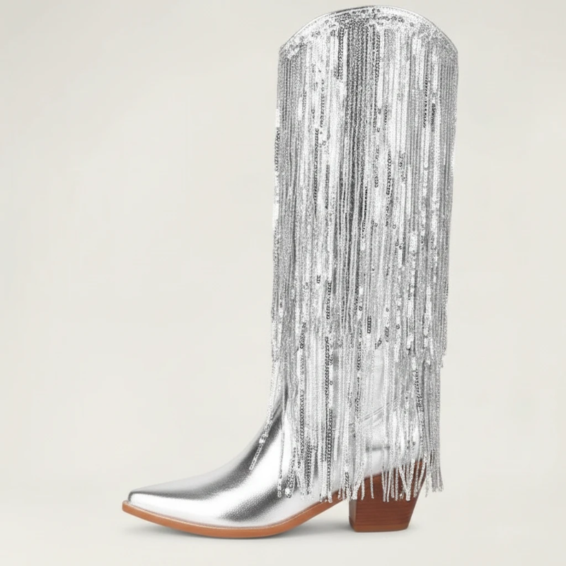 Yehaw silver knee-high vegan leather cowgirl boots with metallic fringe detailing and a pointed toe.