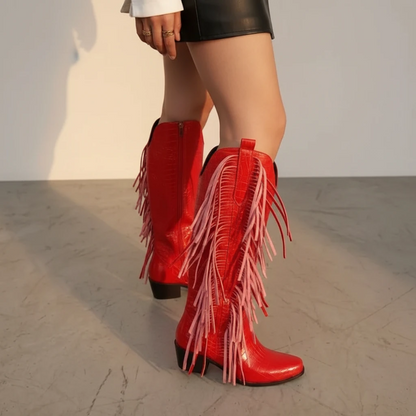 Yehaw red knee-high vegan leather cowgirl boots with fringe detail and square toe worn by a model