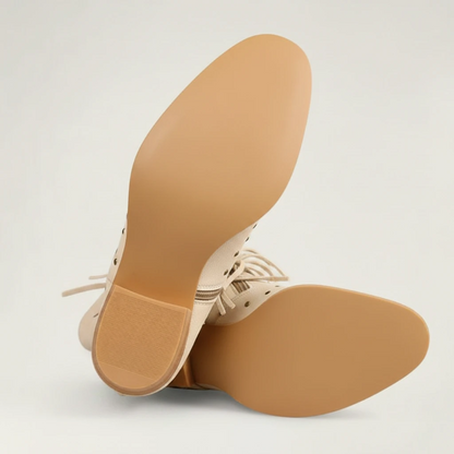 Yehaw beige vegan leather mid-calf cowgirl boots with fringe detailing, round toe, and side zip closure.