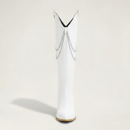 Yehaw white knee-high vegan suede cowgirl boots with pointed toe, block heel, and decorative silver chain detail