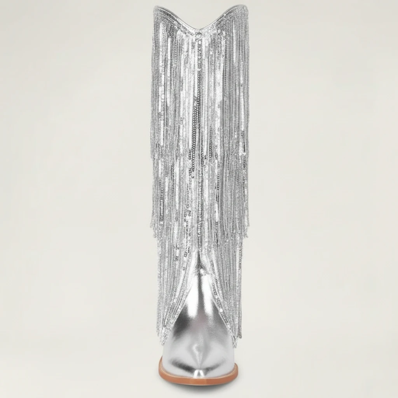 Yehaw silver knee-high vegan leather cowgirl boots with metallic fringe detailing and a pointed toe.