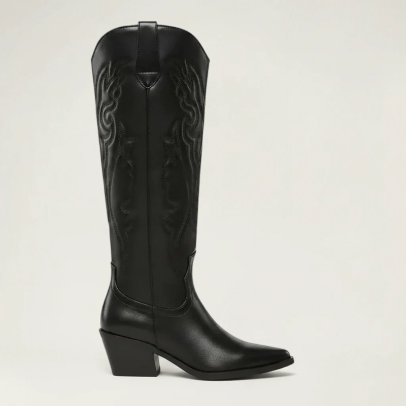 Yehaw black vegan leather knee-high cowboy boots with pointed toe and medium heel. Features intricate western-style embroidery.