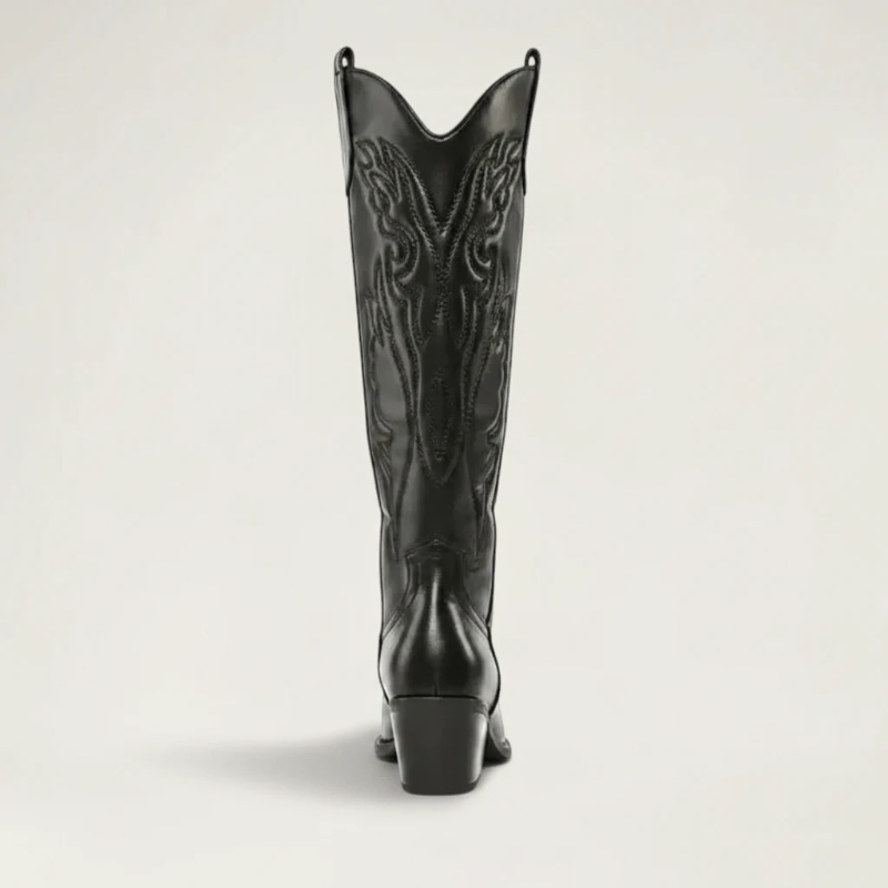 Yehaw black vegan leather knee-high cowboy boots with pointed toe and medium heel. Features intricate western-style stitching.