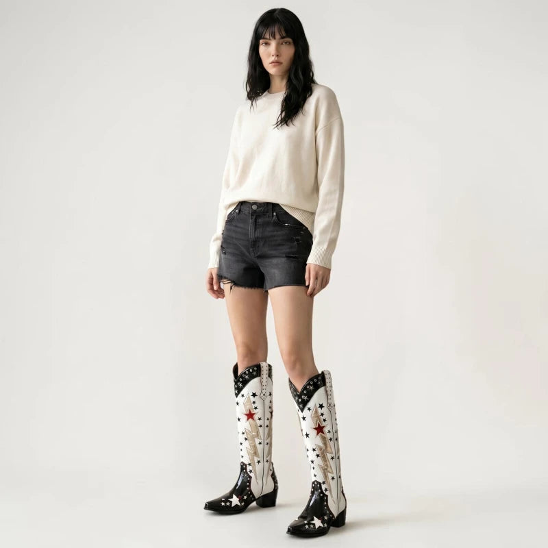 Model wearing Yehaw AMANDA mid-calf vegan leather cowgirl boots with black and white star and lightning bolt patterns.