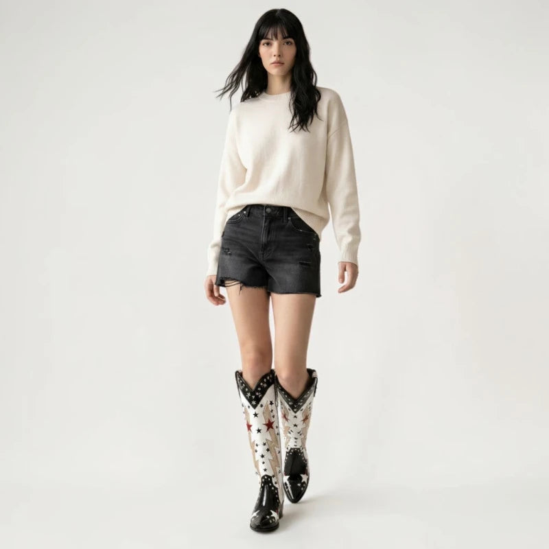 Model wearing Yehaw AMANDA black and white vegan leather mid-calf cowgirl boots with star and lightning bolt details.