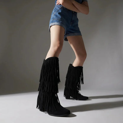Yehaw black vegan suede mid-calf cowgirl boots with fringe detail worn by a model in denim shorts.