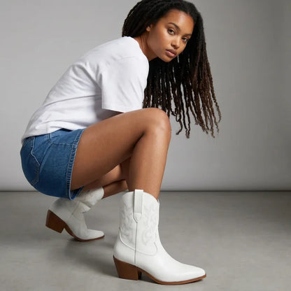 Yehaw white vegan leather ankle-height cowgirl boots with pointed toe and medium heel.