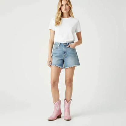 Yehaw pink vegan leather ankle cowboy boots with pointed toe and medium heel, worn by a woman in denim shorts.