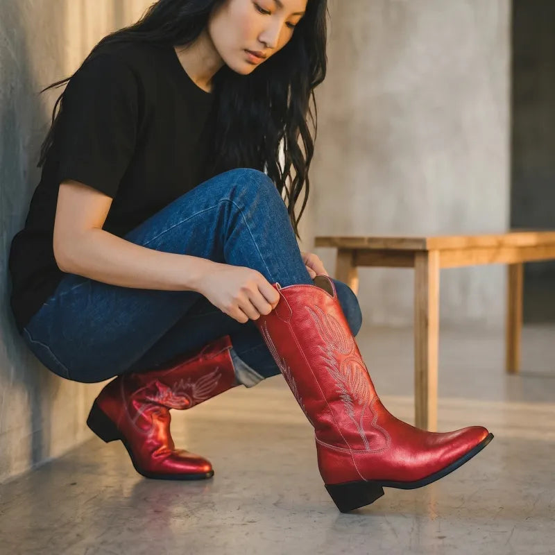 Yehaw red vegan leather mid-calf cowgirl boots with pointed toe and decorative stitching. Woman wearing jeans and black t-shirt.