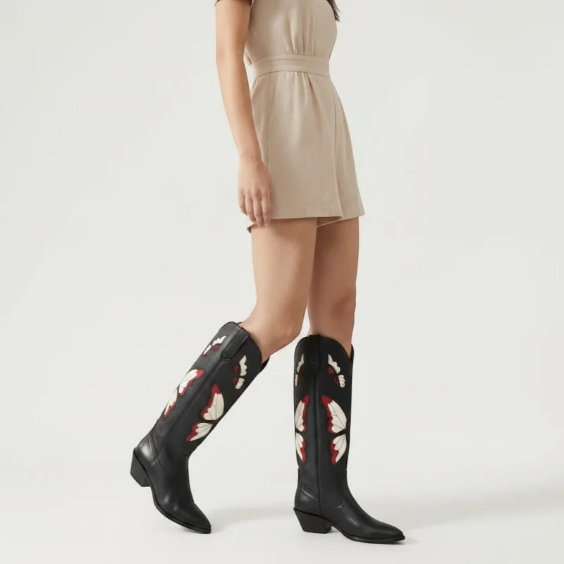 Yehaw CLARA mid-calf black vegan leather cowgirl boots with beige and red butterfly embroidery worn by a model
