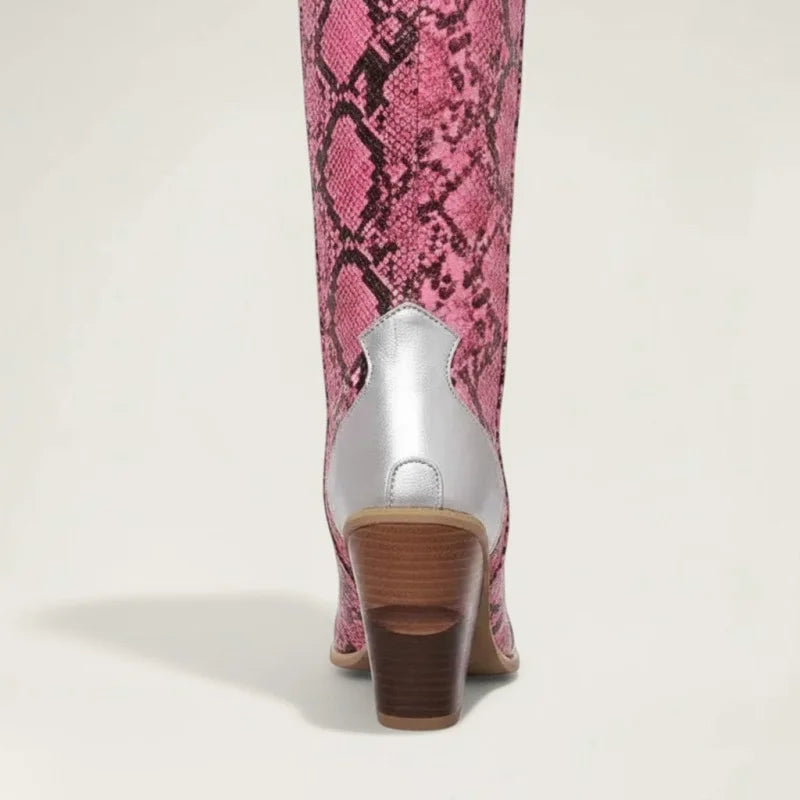 Yehaw Clementine knee-high cowgirl boots in pink snakeskin vegan leather with silver heel detail and stacked block heel