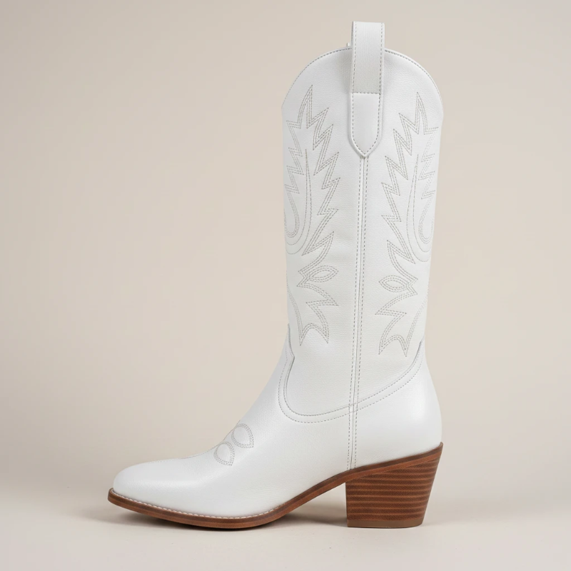 Yehaw white vegan leather mid-calf cowgirl boots with pointed toe and western stitching worn by a woman