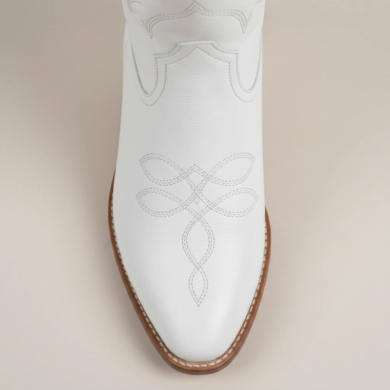 Yehaw white vegan leather mid-calf cowgirl boots with pointed toe and western stitching worn by a woman
