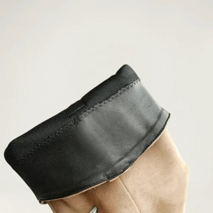 Yehaw beige vegan suede knee-high cowgirl boots with a pointed toe and side zip worn by a woman in denim shorts