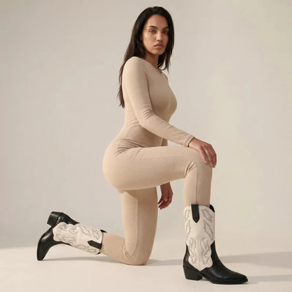 Model wearing Yehaw black and white vegan leather mid-calf cowboy boots with pointed toe and western embroidery