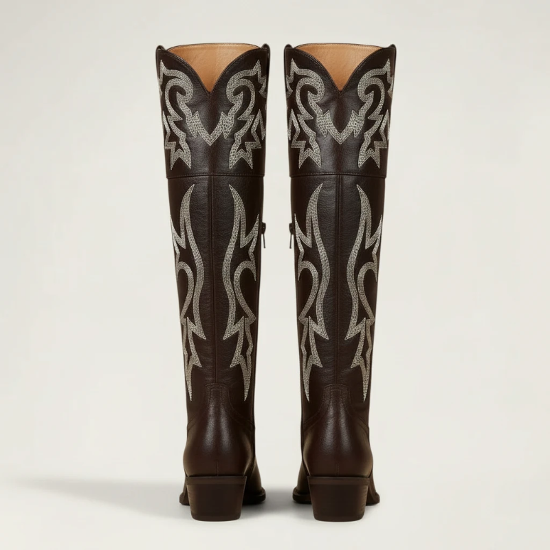 Yehaw brown vegan leather knee-high cowgirl boots with white western embroidery and a pointed toe.
