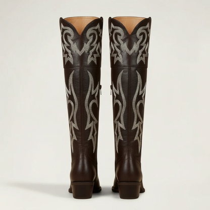 Yehaw brown vegan leather knee-high cowgirl boots with white western embroidery and a pointed toe.