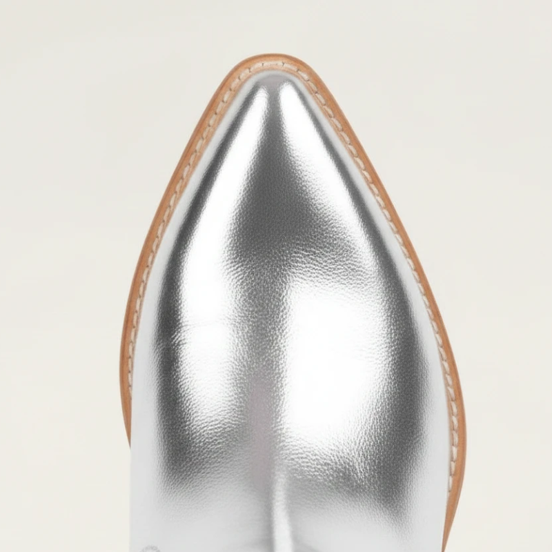 Yehaw silver knee-high vegan leather cowgirl boots with metallic fringe detailing and a pointed toe.