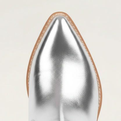 Yehaw silver knee-high vegan leather cowgirl boots with metallic fringe detailing and a pointed toe.