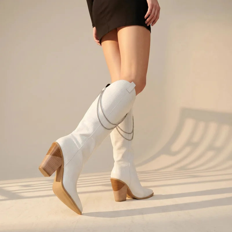 Yehaw white knee-high vegan suede cowgirl boots with pointed toe, block heel, and decorative silver chain detail