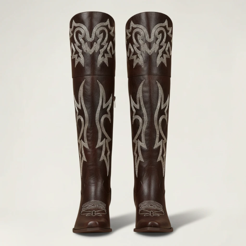 Yehaw brown vegan leather knee-high cowgirl boots with white western embroidery and a pointed toe.