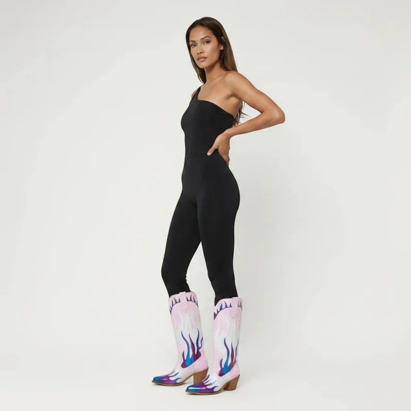 Model wearing Yehaw pink mid-calf vegan leather cowgirl boots with blue flame details and a round toe