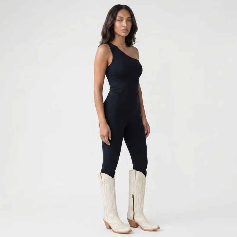 Model wearing Yehaw white vegan leather knee-high cowgirl boots with pointed toes and side zip closure