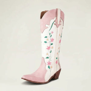 Yehaw knee-high vegan leather cowgirl boots in white and pink with floral embroidery and a pointed toe.
