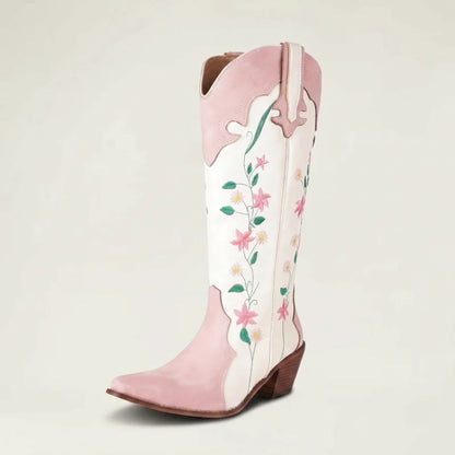 Yehaw knee-high vegan leather cowgirl boots in white and pink with floral embroidery and a pointed toe.