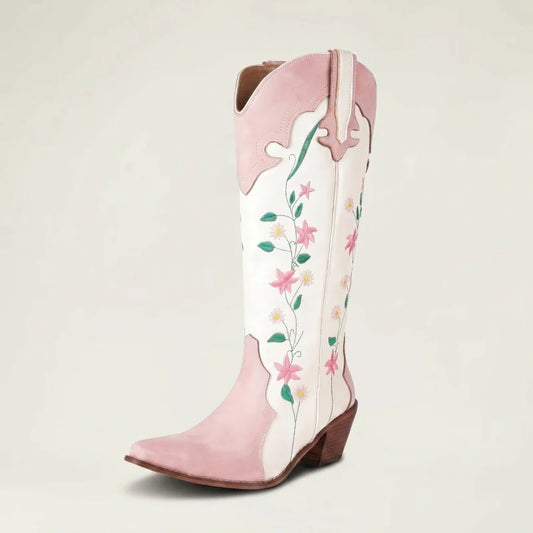 Yehaw knee-high vegan leather cowgirl boots in white and pink with floral embroidery and a pointed toe.